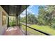 Relaxing screened patio overlooking the lush backyard, perfect for enjoying the outdoors at 107 Woodland Pl # 107, Osprey, FL 34229