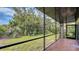 Nice screened patio overlooking a manicured lawn and vibrant landscaping at 107 Woodland Pl # 107, Osprey, FL 34229