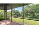 Inviting screened patio with tile flooring, offering a serene outdoor space at 107 Woodland Pl # 107, Osprey, FL 34229