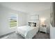 Bright bedroom with a cozy bed, large window, and neutral color palette at 1074 Bristol St, Port Charlotte, FL 33952