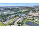 Expansive community view showing the tranquil lake, verdant green spaces, and a variety of well-built homes at 11507 84Th Street E Cir # 102, Parrish, FL 34219