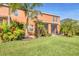 Spacious backyard featuring lush landscaping, palm trees, and a screened-in lanai at 11507 84Th Street E Cir # 102, Parrish, FL 34219