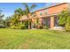 Lush backyard with tropical plants and screened lanai enhances outdoor living at 11507 84Th Street E Cir # 102, Parrish, FL 34219