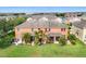 Expansive backyard with well-manicured lawn, tropical landscaping, and a view of nearby homes and a pond at 11507 84Th Street E Cir # 102, Parrish, FL 34219