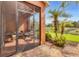 Exterior view from screened lanai, showcasing Florida landscaping and community pond at 11507 84Th Street E Cir # 102, Parrish, FL 34219