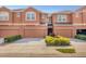 Charming townhome showcasing well-kept landscaping, private garages, and a welcoming front entrance at 11507 84Th Street E Cir # 102, Parrish, FL 34219