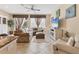 Cozy living room featuring tile flooring, plush sectional, and a ceiling fan at 11507 84Th Street E Cir # 102, Parrish, FL 34219