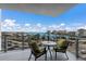 Balcony with comfortable seating overlooking a marina and cityscape beyond at 1155 N Gulfstream Ave # 406, Sarasota, FL 34236