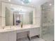 Bathroom featuring double vanity sinks, and a large marble shower at 1155 N Gulfstream Ave # 406, Sarasota, FL 34236