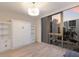 This is a bright bedroom with a murphy bed, a modern light fixture, and expansive windows offering city views at 1155 N Gulfstream Ave # 406, Sarasota, FL 34236