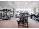 Bright gym with floor to ceiling windows, multiple exercise machines, and mirrored walls at 1155 N Gulfstream Ave # 406, Sarasota, FL 34236