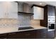 Modern kitchen with mosaic backsplash, stainless appliances, and dark wood cabinets at 1155 N Gulfstream Ave # 406, Sarasota, FL 34236