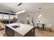 Bright, open-concept living space with modern dining set and beautiful water views at 1155 N Gulfstream Ave # 406, Sarasota, FL 34236