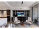 Bright living room with modern decor, open layout, and view of the balcony, media center, and kitchen at 1155 N Gulfstream Ave # 406, Sarasota, FL 34236