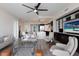 Spacious living room with a large built-in media center, modern furniture, and a glimpse of the kitchen at 1155 N Gulfstream Ave # 406, Sarasota, FL 34236