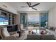 Cozy living room with open balcony overlooking a marina view and comfortable contemporary furniture at 1155 N Gulfstream Ave # 406, Sarasota, FL 34236