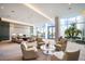 Open lobby area with stylish seating, modern decor, and large windows with views of the lush surroundings at 1155 N Gulfstream Ave # 406, Sarasota, FL 34236