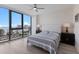 Bedroom with large window, water view, ceiling fan, and tufted headboard at 1155 N Gulfstream Ave # 406, Sarasota, FL 34236