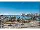 Expansive water view showcasing a bustling marina, clear blue skies, and lush palm trees lining the waterfront at 1155 N Gulfstream Ave # 406, Sarasota, FL 34236