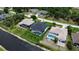 An aerial view displays the home's backyard pool and its proximity to the canal and neighboring properties at 117 Marker Rd, Rotonda West, FL 33947