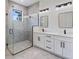 Modern bathroom with double vanity, sleek mirrors, and glass shower enclosure at 117 Marker Rd, Rotonda West, FL 33947