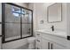 Modern bathroom features white vanity, matte black fixtures, and a tiled shower with glass door at 117 Marker Rd, Rotonda West, FL 33947