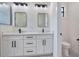 Modern bathroom with double vanity, sleek mirrors and black fixtures at 117 Marker Rd, Rotonda West, FL 33947