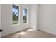 Bright bedroom with two windows and light wood flooring at 117 Marker Rd, Rotonda West, FL 33947