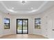 Bedroom with a sliding glass door and windows that overlook the pool at 117 Marker Rd, Rotonda West, FL 33947