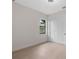 Bright bedroom showcasing sleek, wood-look floors, a window, and a closet with sliding doors at 117 Marker Rd, Rotonda West, FL 33947