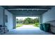 Spacious garage with an overhead door offers views of the home's manicured front yard at 117 Marker Rd, Rotonda West, FL 33947