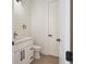 Half bathroom features a modern vanity, white door, and black fixtures at 117 Marker Rd, Rotonda West, FL 33947