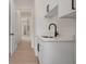 Bright hallway with white cabinets, black hardware, and a modern black faucet at 117 Marker Rd, Rotonda West, FL 33947