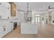 Modern kitchen featuring a large island, stainless steel appliances and hardwood floors at 117 Marker Rd, Rotonda West, FL 33947