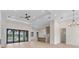 Bright, open-concept living room features wood floors, recessed lighting, and sliding glass doors to outdoor pool at 117 Marker Rd, Rotonda West, FL 33947