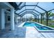 Stunning pool and spa area features an expansive screened enclosure and lush tropical landscaping at 117 Marker Rd, Rotonda West, FL 33947
