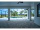 Covered lanai overlooks sparkling pool and spa, offering serene water views and lush landscaping at 117 Marker Rd, Rotonda West, FL 33947