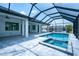 A beautiful screened pool with attached spa and covered patio provides private backyard relaxation at 117 Marker Rd, Rotonda West, FL 33947