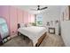 Chic bedroom featuring a pink accent wall, makeup vanity, and modern decor at 11783 Moonsail Dr, Parrish, FL 34219