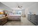 Cozy bedroom features a large bed, patterned bedding, and soft natural light from the window at 11783 Moonsail Dr, Parrish, FL 34219