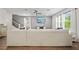 Bright living room featuring a large sectional sofa, modern decor, and a staircase leading to the upper level at 11783 Moonsail Dr, Parrish, FL 34219