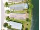 Aerial view of a property with a pool, situated on a waterfront lot, offering serene views and privacy at 12183 Longview Lake Cir, Bradenton, FL 34211