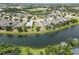 Wide aerial view of homes near a scenic lake, highlighting the community's attractive landscaping and peaceful setting at 12183 Longview Lake Cir, Bradenton, FL 34211