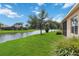 Picturesque view of the tranquil lake and lush backyard from the property at 12183 Longview Lake Cir, Bradenton, FL 34211