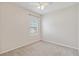 Cozy carpeted bedroom with a ceiling fan and a window view at 12183 Longview Lake Cir, Bradenton, FL 34211