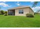 Back exterior view with screened-in lanai and expansive lawn at 12183 Longview Lake Cir, Bradenton, FL 34211