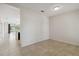 Neutral-toned hallway leads to an open-concept living space with tile flooring and abundant natural light at 12183 Longview Lake Cir, Bradenton, FL 34211