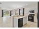 Bright kitchen flows to living area with modern appliances, tiled floor, and scenic views at 12183 Longview Lake Cir, Bradenton, FL 34211