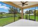 Relaxing screened-in lanai overlooking the serene lake and lush greenery at 12183 Longview Lake Cir, Bradenton, FL 34211