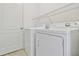 Neat laundry area with white washer and dryer units and wire shelving at 12183 Longview Lake Cir, Bradenton, FL 34211
